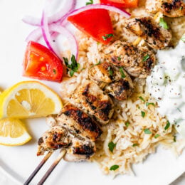 Grilled Chicken Kabobs on a plate with rice pilaf