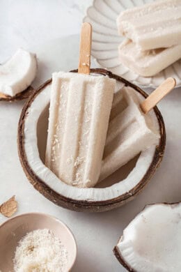 Two coconut cream pops set in halved coconut