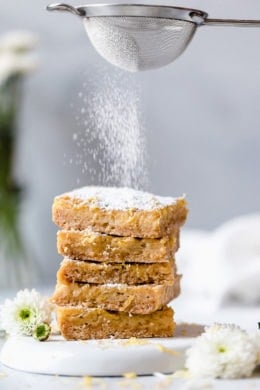 Pucker Up! These sweet and tangy Honey Lemon Bars made with fresh lemon, lemon zest and honey and a whole wheat shortbread crust are a little lighter than traditional lemon bars, but are so tasty and hard to resist.