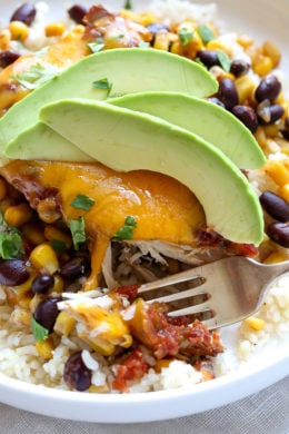 This EASY Slow Cooker Chicken dish is cheesy and delicious, made with boneless chicken breast, black beans, corn and salsa topped with melted cheddar cheese. YUM!